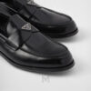 Giày loafer Prada màu đen logo bạc chính hãng NGP001 2026 Giày loafer Prada màu đen logo bạc chính hãng NGP001 2026